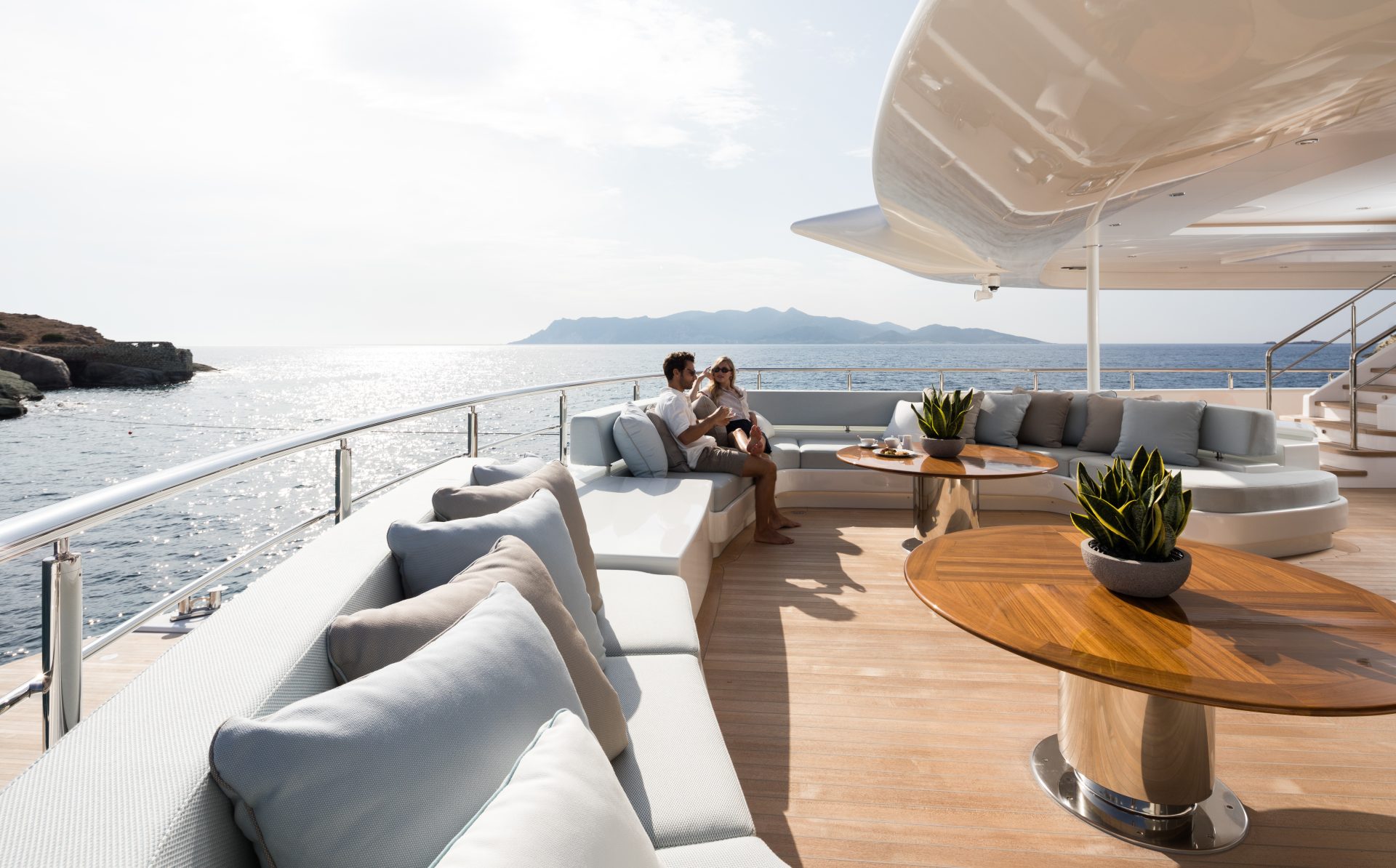 Couple enjoying drinks on superyacht deck