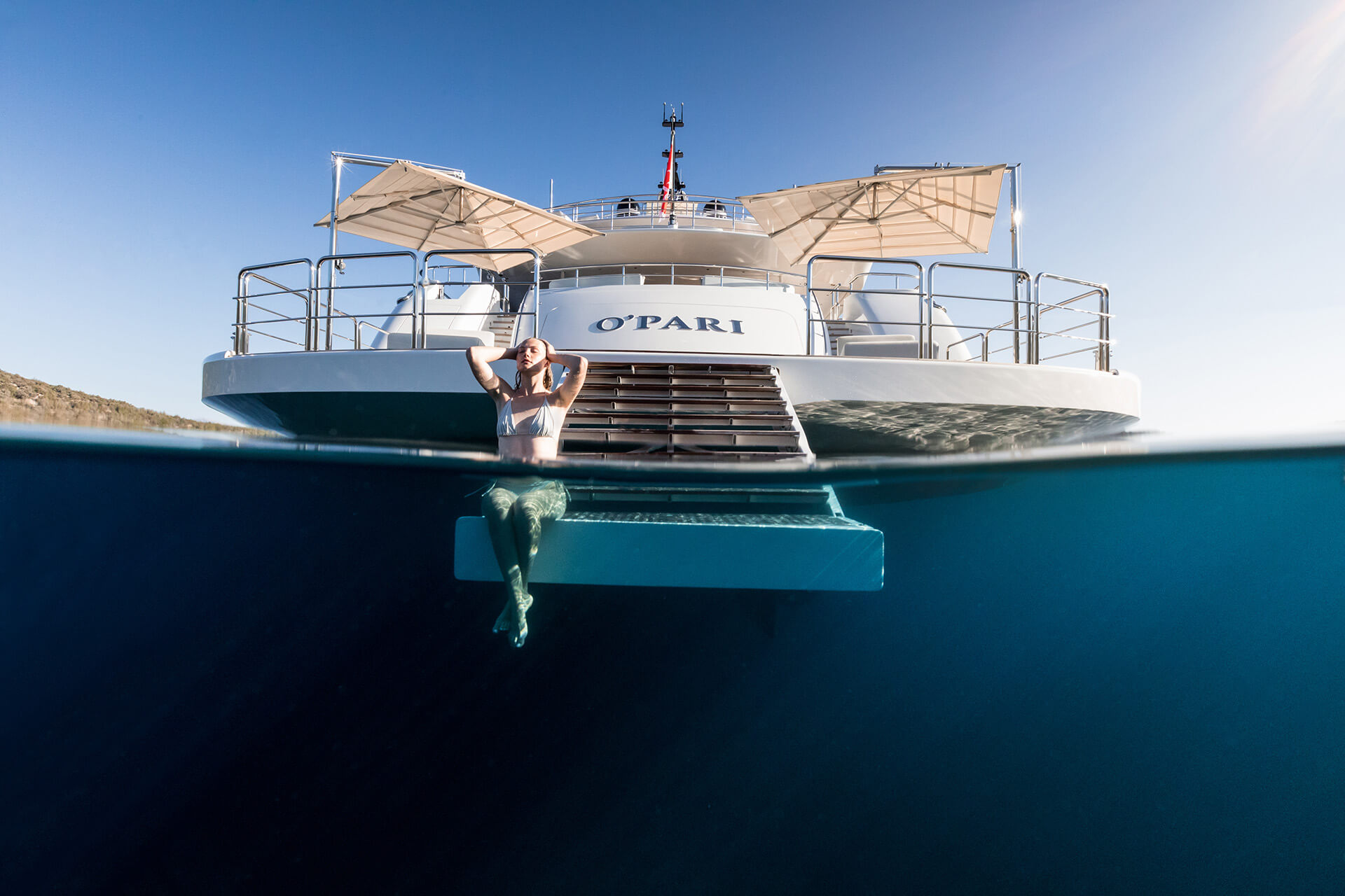 Woman swimming from super yacht