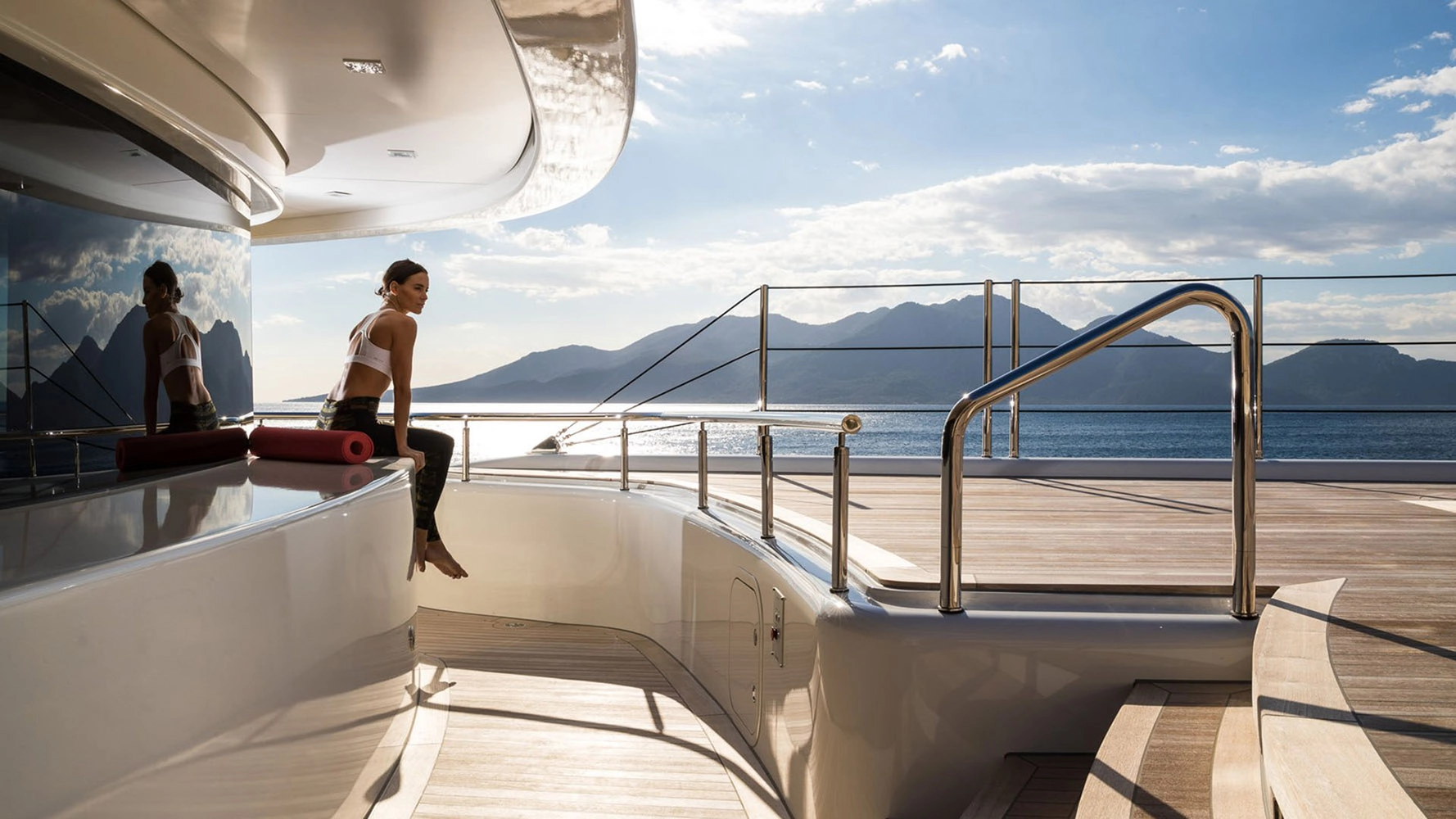 Woman sitting enjoying sunshine on superyacht